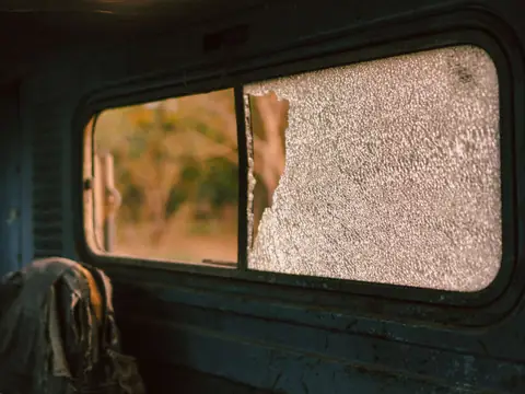 A shattered side window in a vehicle door